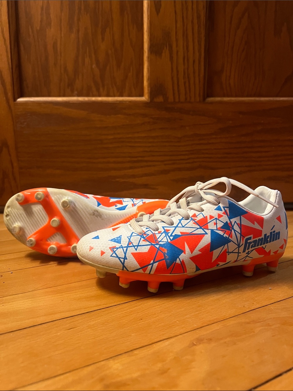 Franklin Kids White Soccer Cleats with Orange & Blue Graphic Design